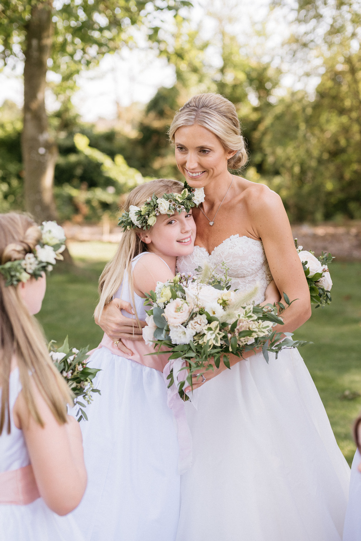 The bride and her flower girls wearing Little Eglantine flower girl dresses