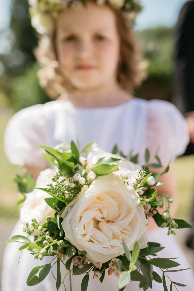 lovely flower girl in an countryside wedding in white and pink